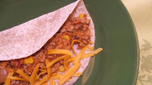 Turkey and bean tacos on a green plate