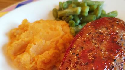 Turkey meatloaf with green beans and sweet potato mash on plate