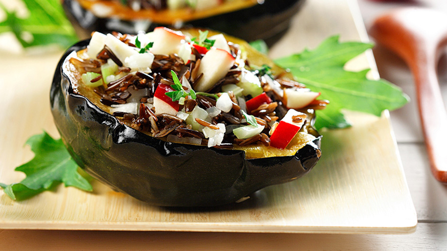 Two Wild rice and apple stuffed acorn squash halves