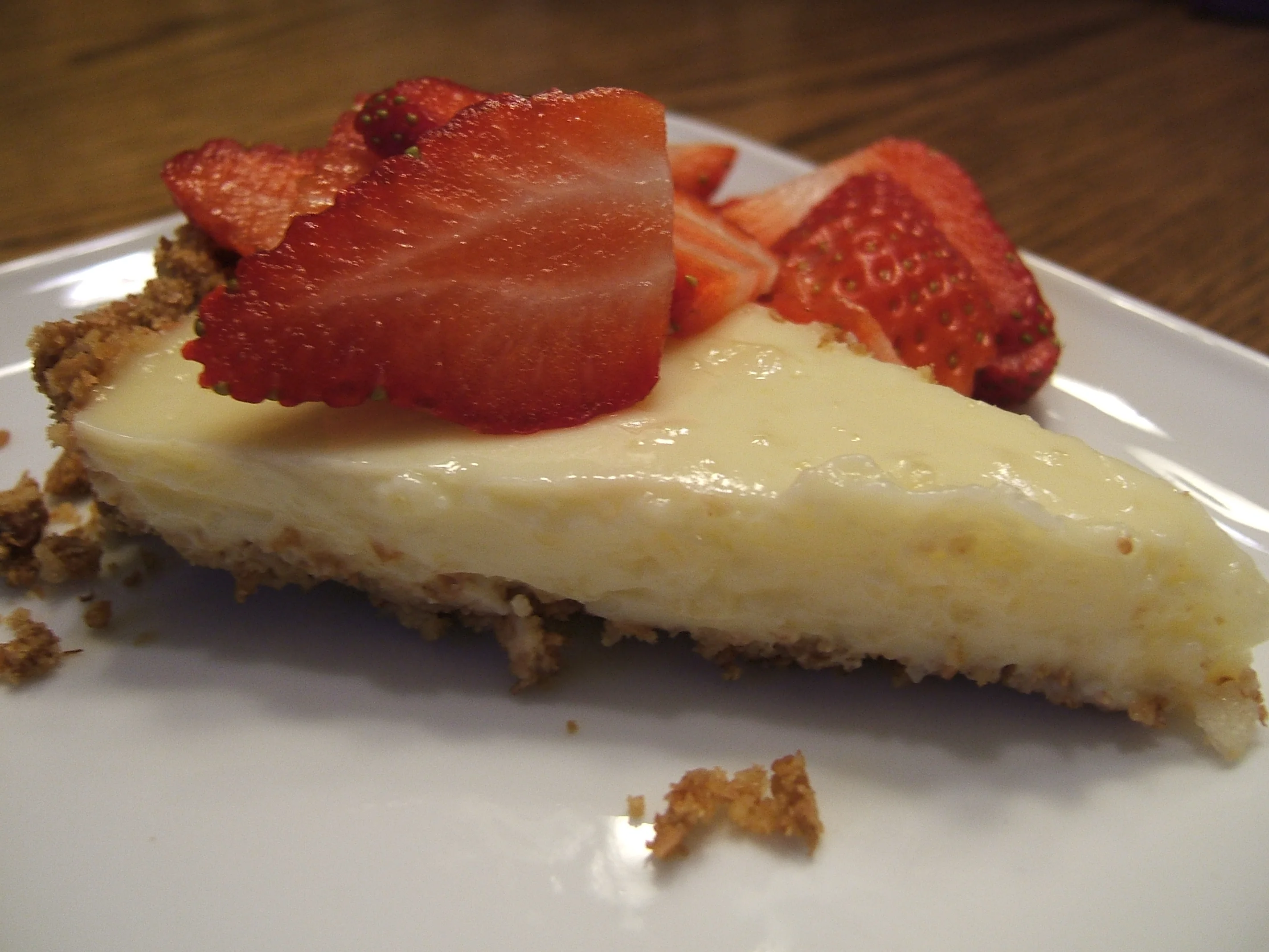Tangy lemon custard pie with strawberry slices on top