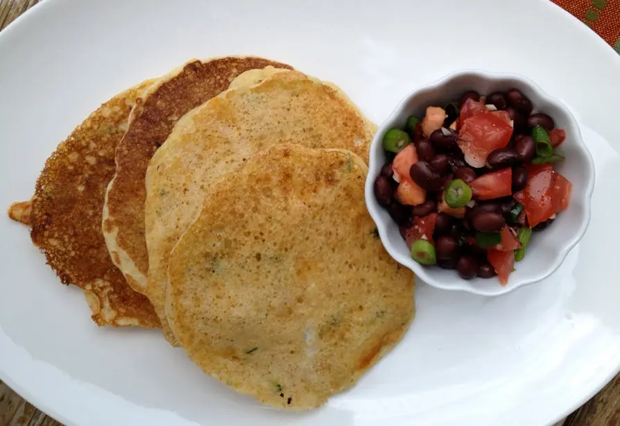 Pancakes with bean and tomato salsa on a plate