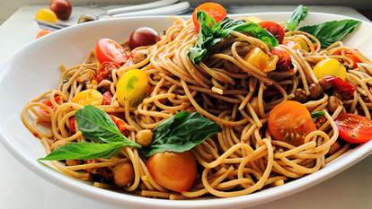 Spaghetti with cherry tomatoes in a white dish