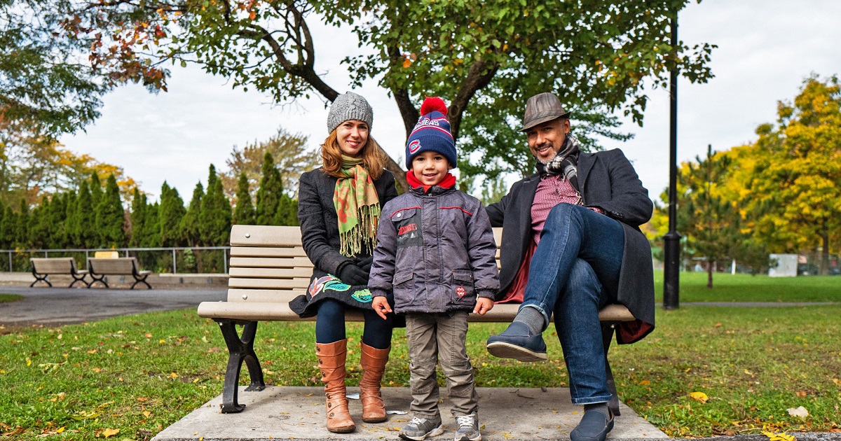 Dani with his mother and father in a city park