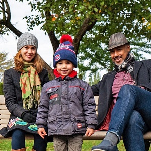 Dani with his mother and father in a city park