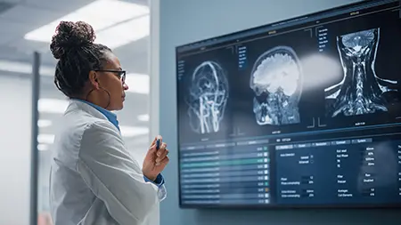 A doctor looking at brain scans