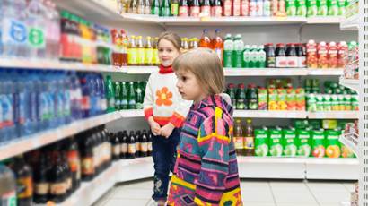 Little girls choosing products in supermarket
