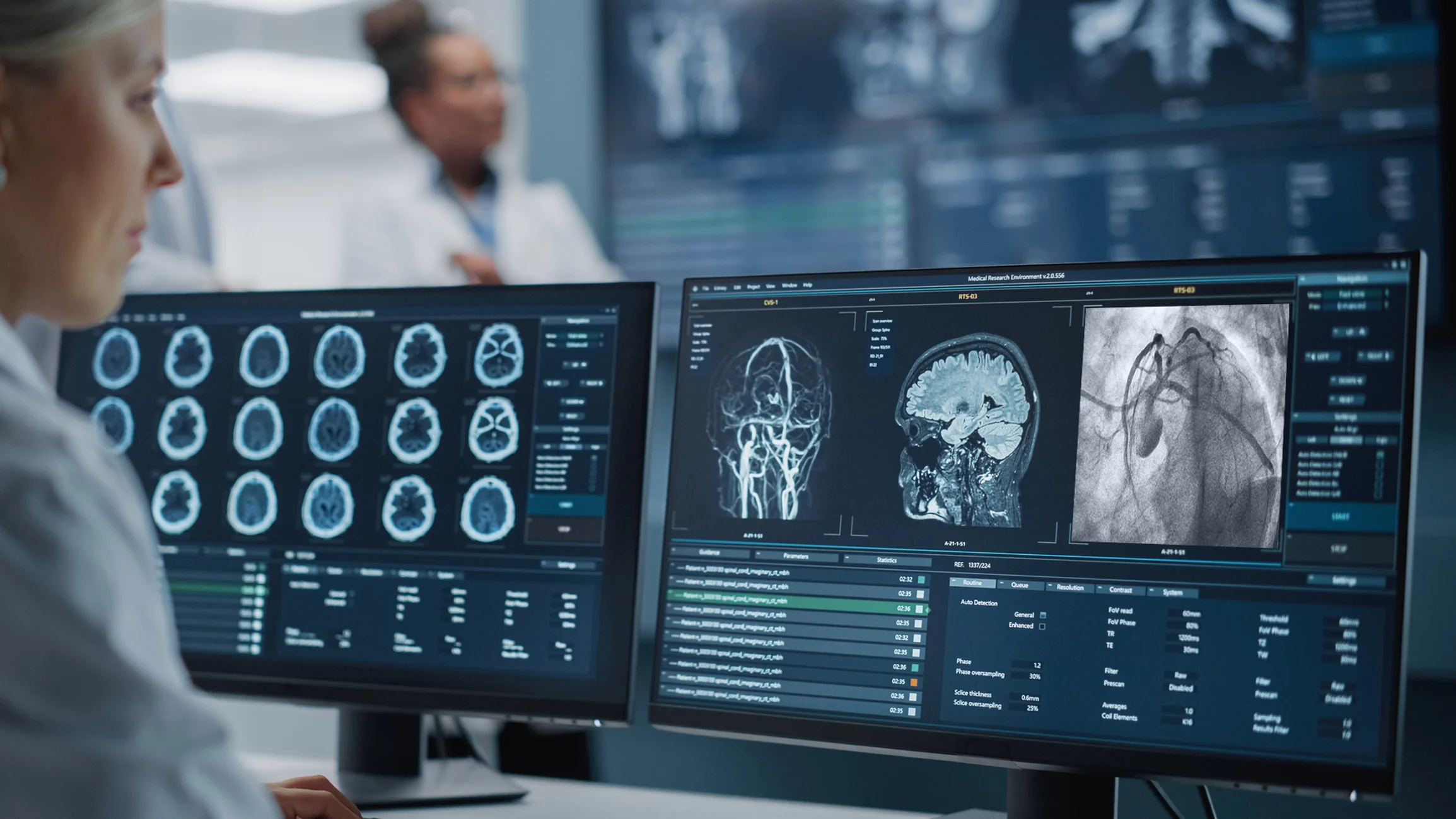 A researcher examines brain and heart scans on a computer screen.
