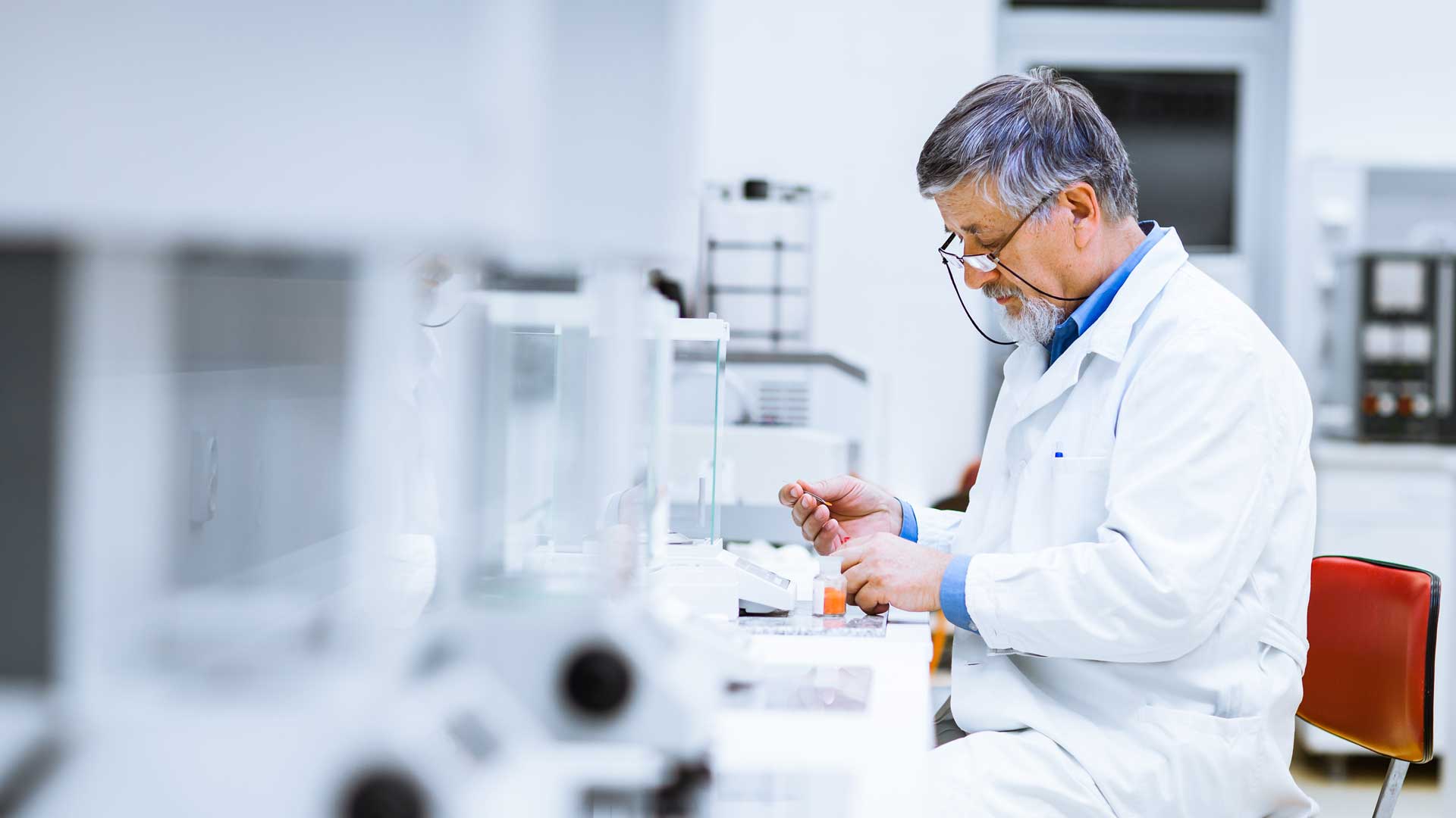 Senior male researcher carrying out scientific research in a lab