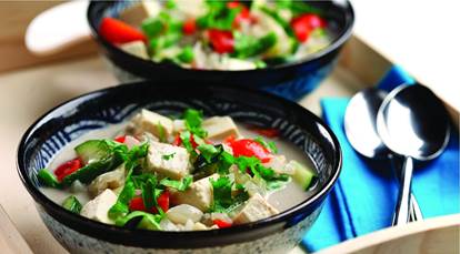 Bowls of tofu cubes, cilantro, red pepper, zucchini and broth 