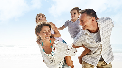 A family walking together on the beach.