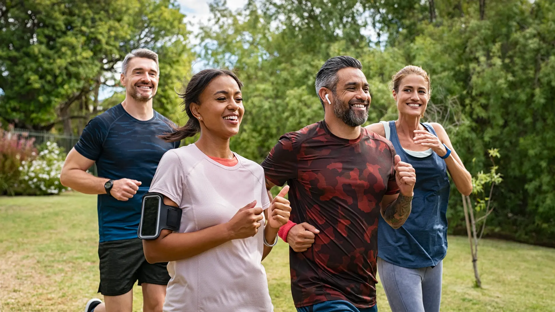 A small group of people jogging outdoors.