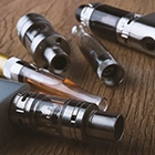 Five vapes on a table.