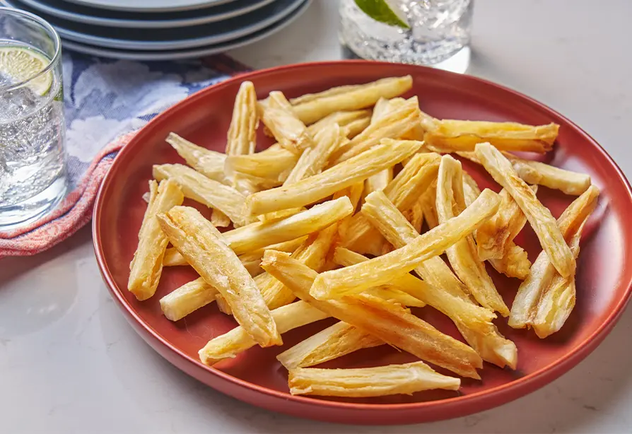 Cassava fries on a red plate.