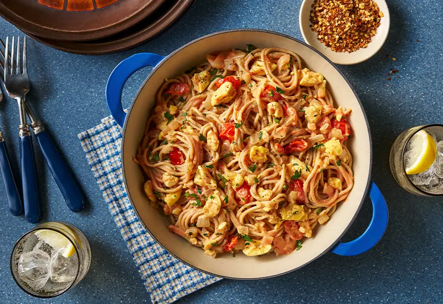 Ackee and spaghetti in a blue-handed skillet 