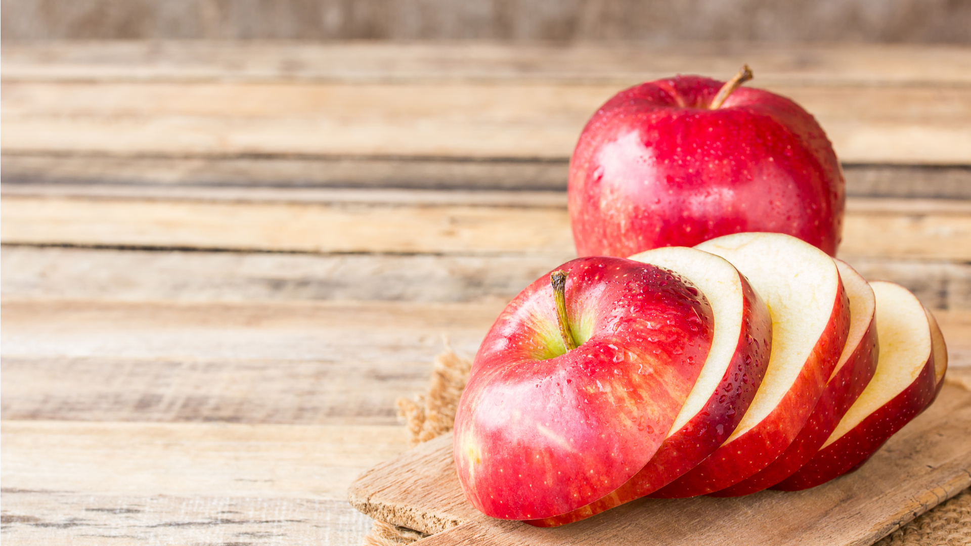 Apple slices on wooden board