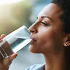 A woman drinking a glass of water