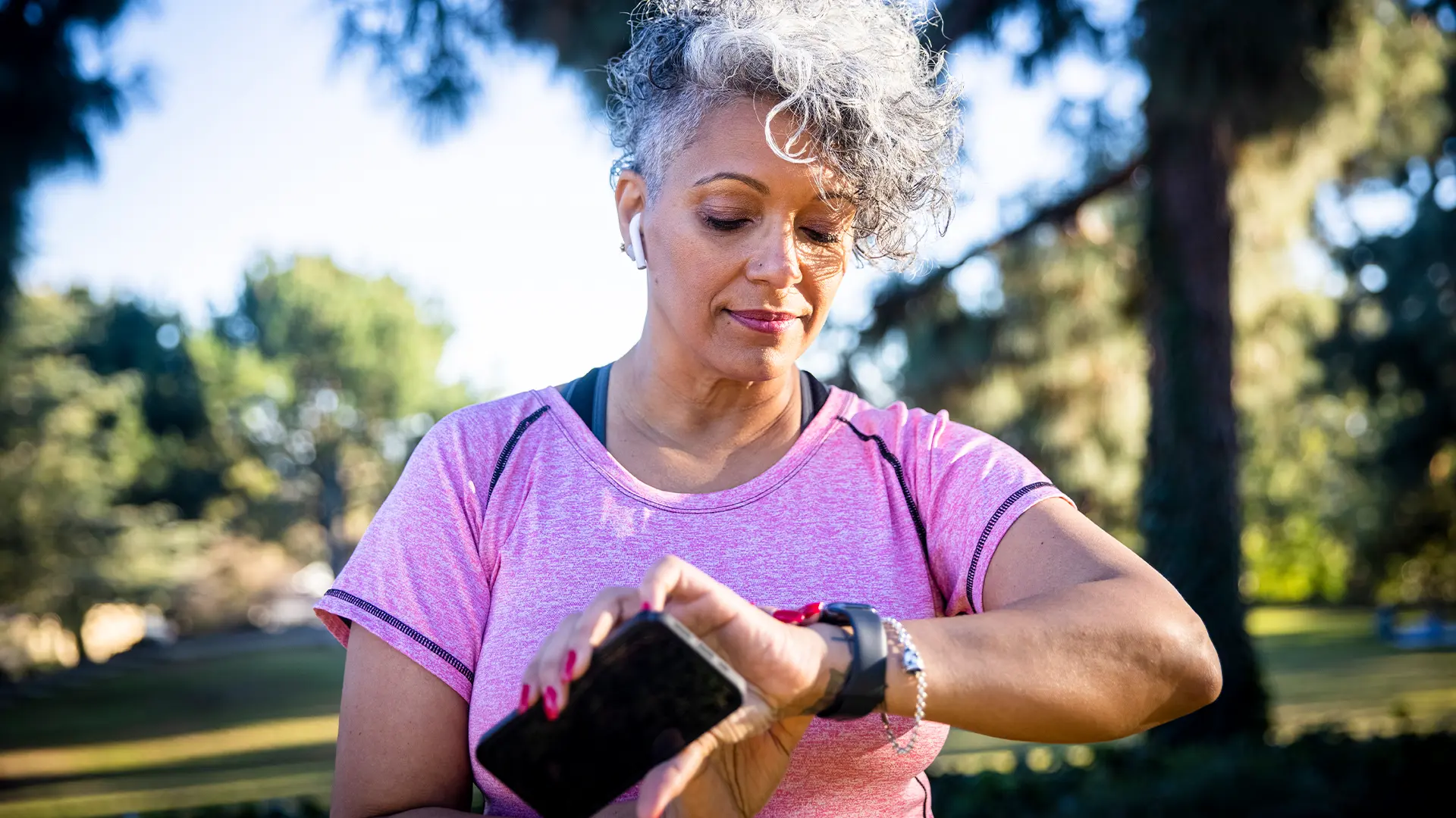 A woman looking at her smartwatch during an exercise session.
