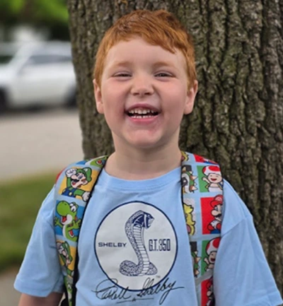 Charlie excited to be back in the classroom with his friends.