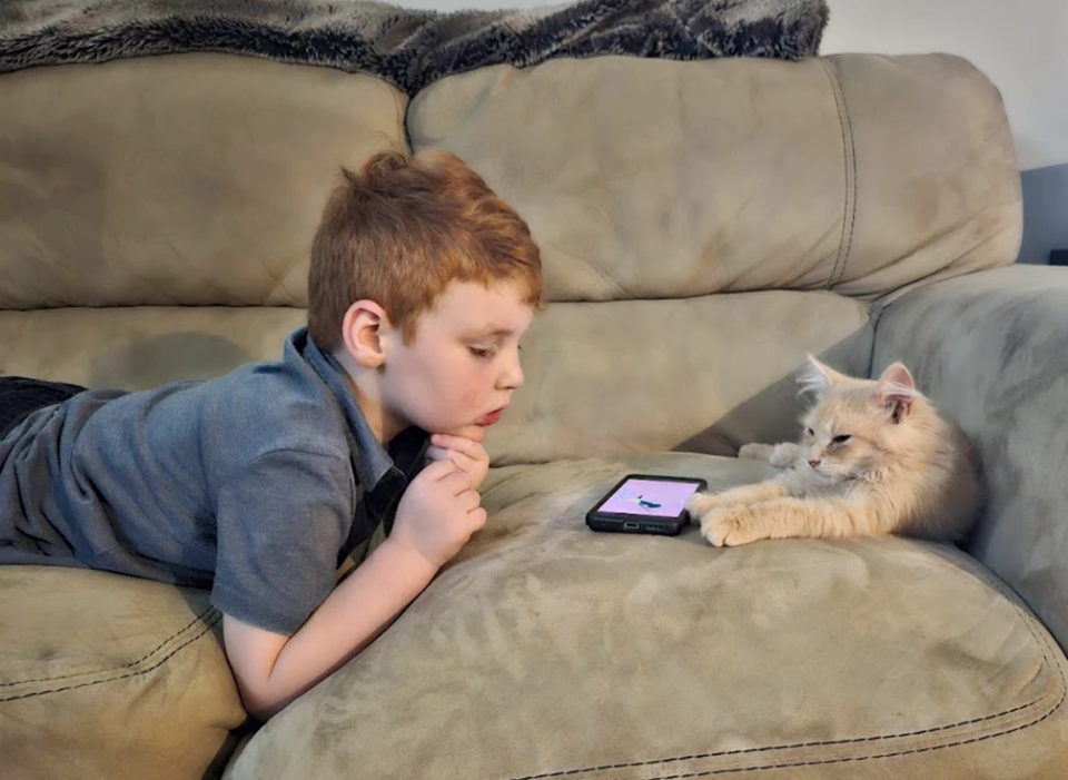 Charlie and his furry friend hanging out on the couch.