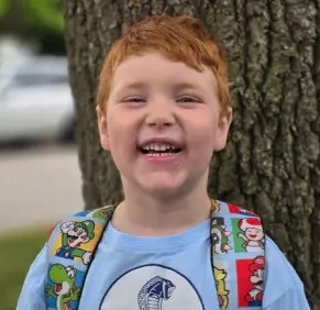 Charlie excited to be back in the classroom with his friends.