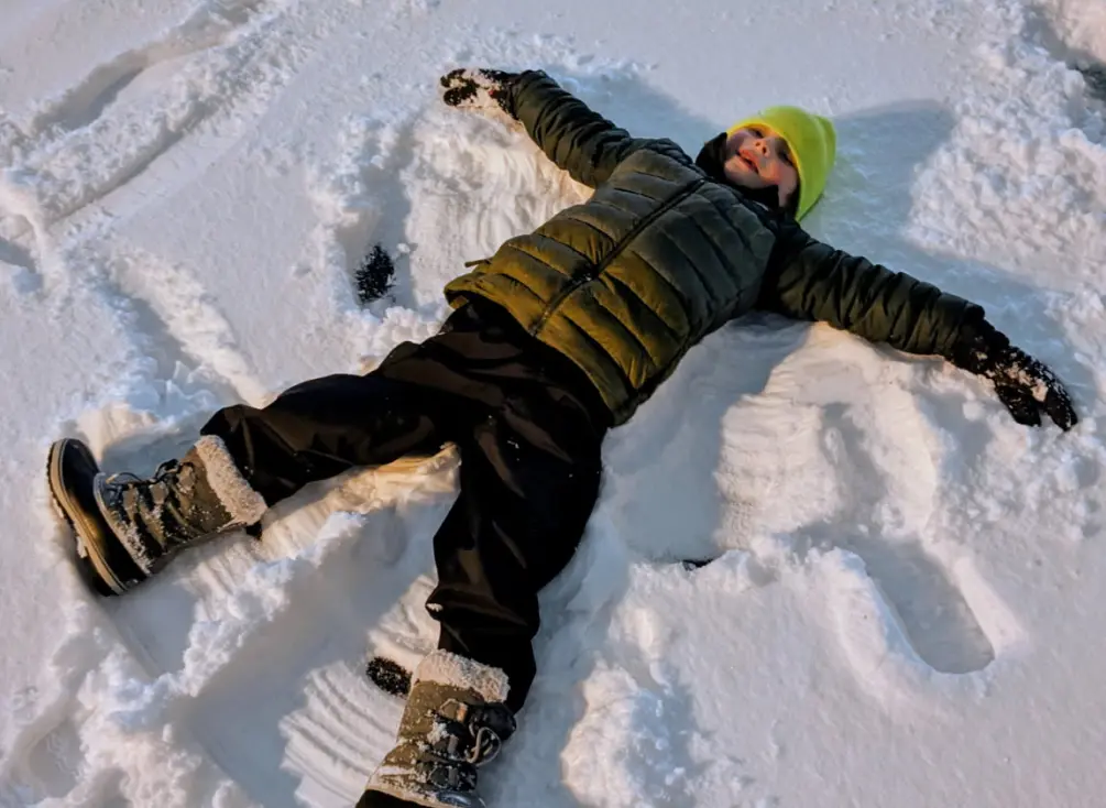 Logan making snow angels.