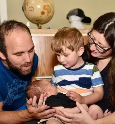 Logan welcoming his younger brother into the world. 