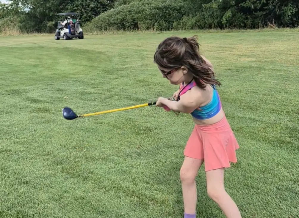 Natalie enjoying a great day on the golf course.