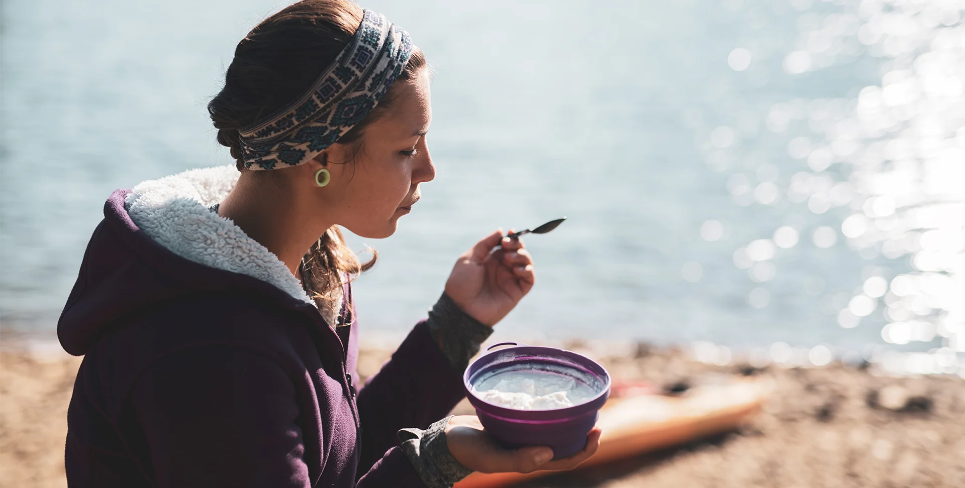 A woman eating oatmeal.