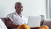 Senior woman using laptop while sitting on couch