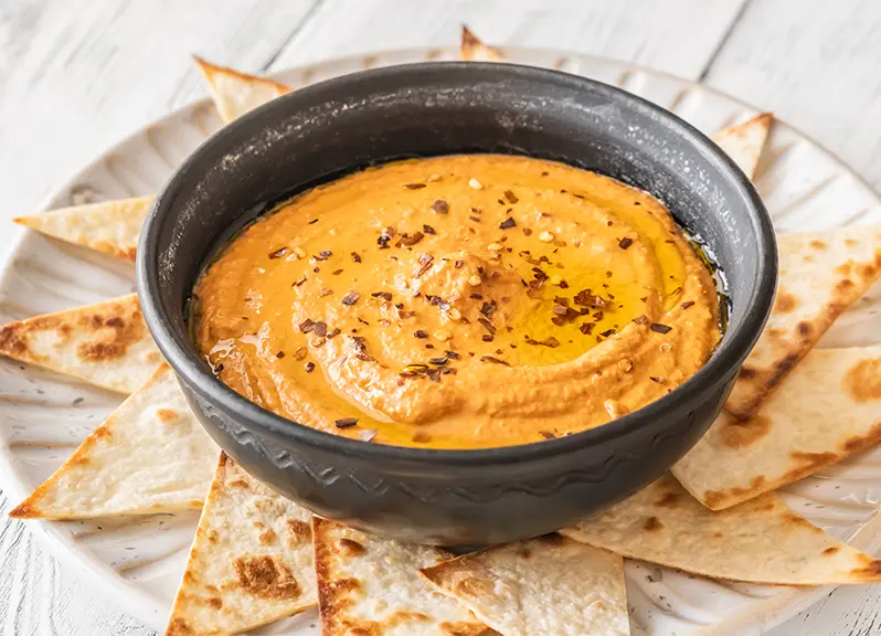 Herb pita crisps with roasted carrot dip