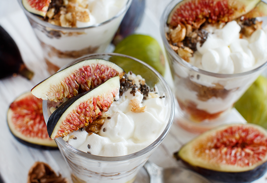 Greek yogurt and poached fig parfait in a glass bowl