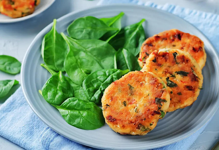 Salmon sliders with spinach on a plate