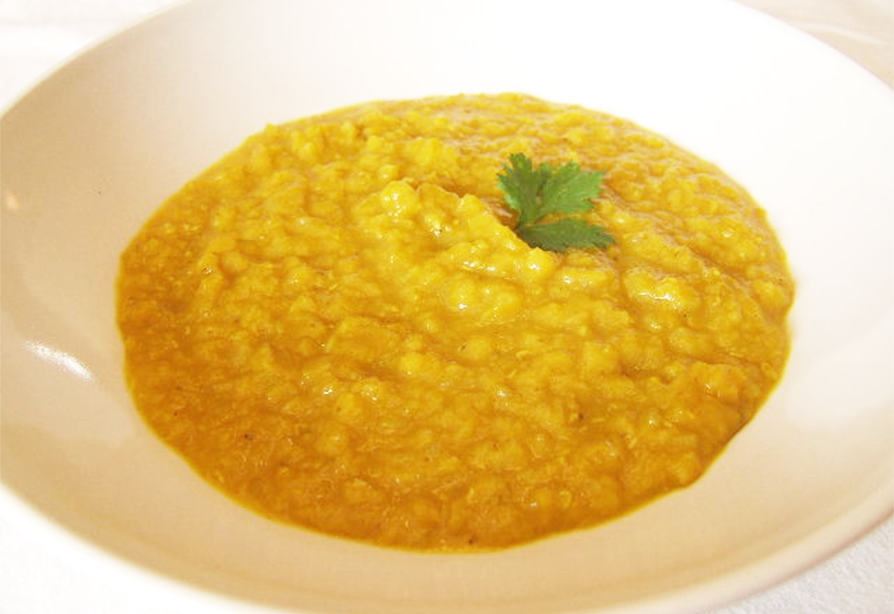 Ginger and spice dal soup in a white bowl