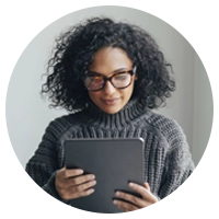 A woman in glasses looking downward.