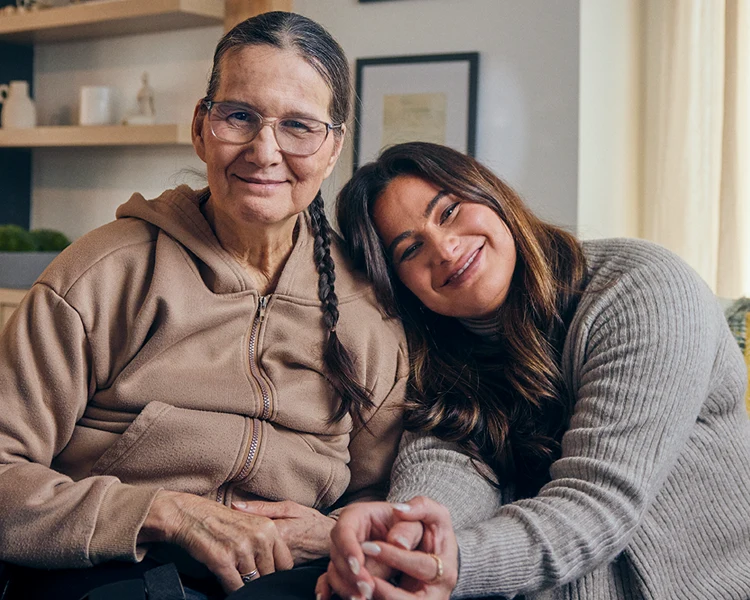 Lynne Marie Sherry, living with stroke, and her daughter Shawnee Kish. In the bottom right, a laptop and a smartphone displaying the risk screening tool.