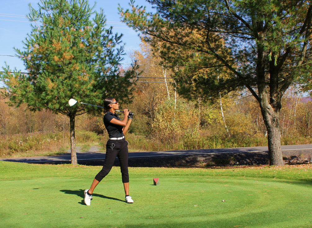 Caroline Lavallée looks into the distance after hitting a golf ball