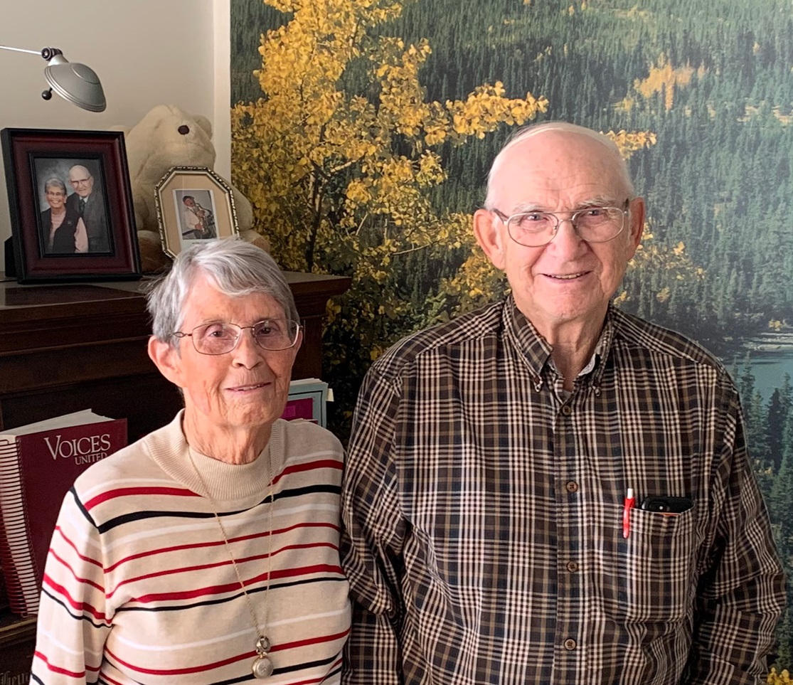 Carol and Barrie Clayton pose for a photo indoors. 