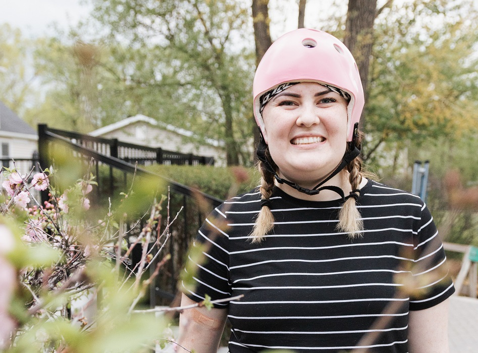 Courtney wears a pink helmet to protect her head after part of her skull was removed.