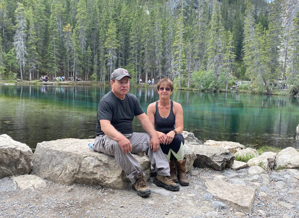 Darrell and his wife, Shirley, sit by a creek at the trail.
