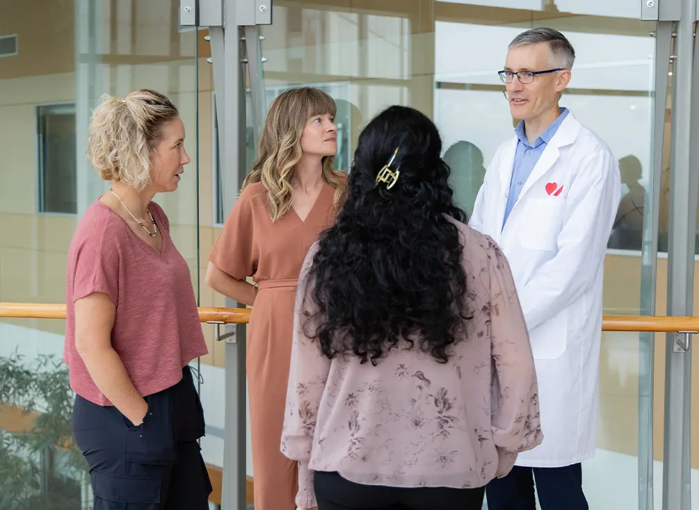 Dr. Andrew Mackie talks to Haima Kapoor - a person living with congenital heart disease -  nurse Jody Gingrich, and Alyssa Chappell.