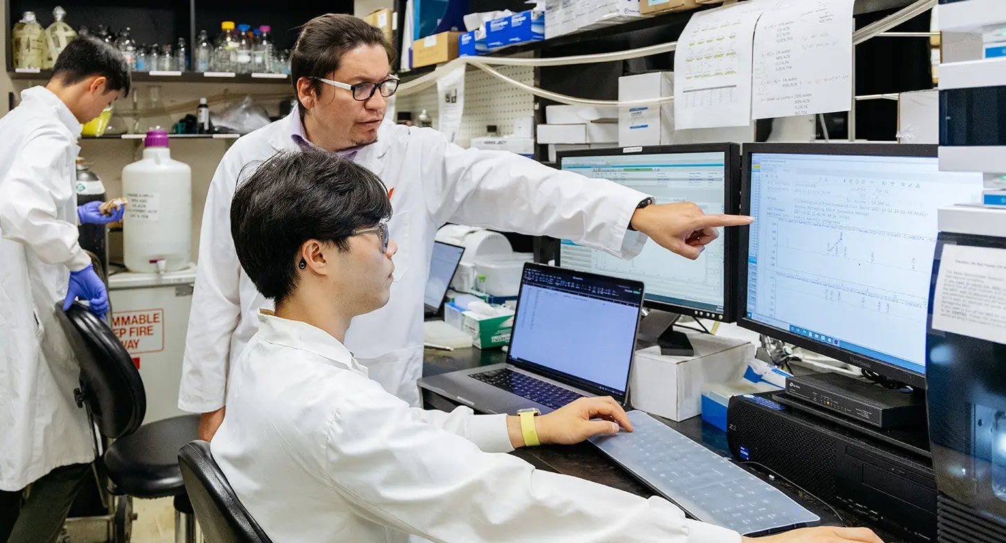 Dr. Emilio Alarcón with his research assistants, Bryan Liu and Ryan Tu, at their lab.