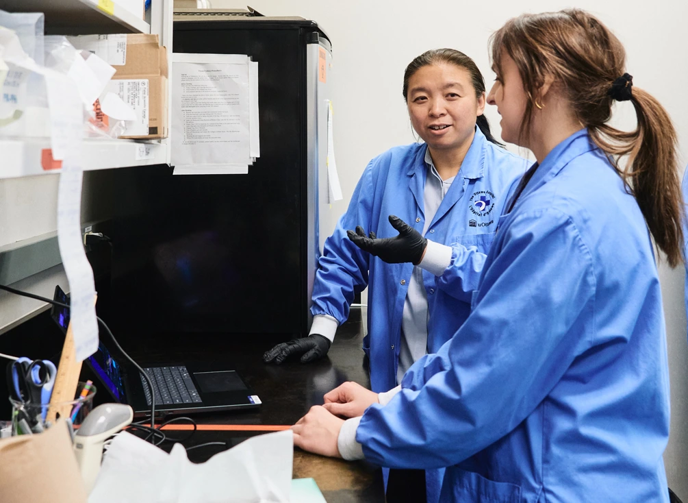 Dr. Jing Wang with a colleague in the laboratory;