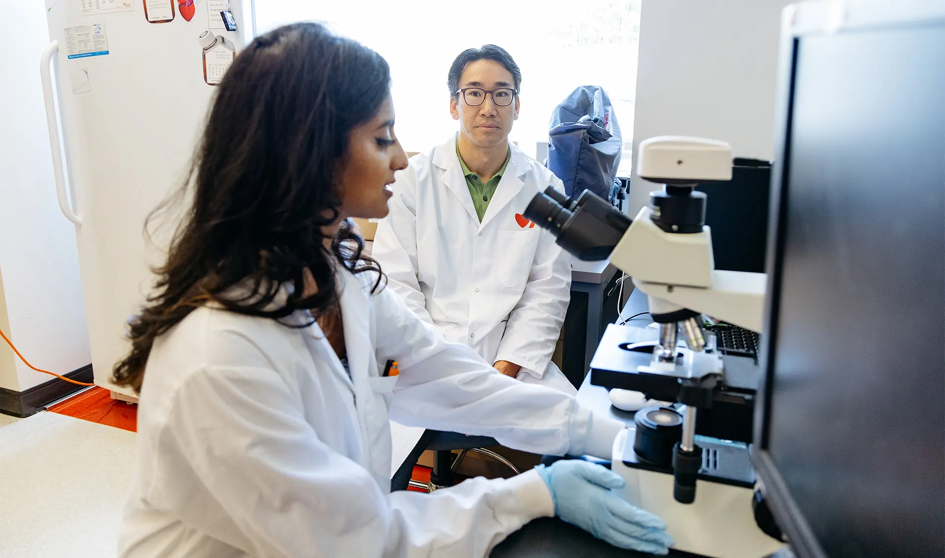 Dr. Jonathan Choy and his research assistant, Javairia Rahim, inspect a sample at their lab.