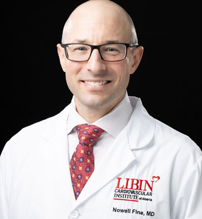 Dr. Nowell Fine in a white lab coat.