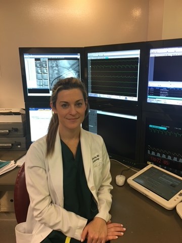 Cardiologist Dr. Joza at her desk in her lab