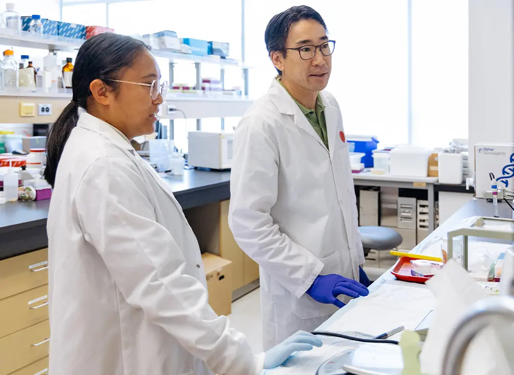 Dr. Jonathan Choy talking to his research assistant Jenice Dumlao at their lab.