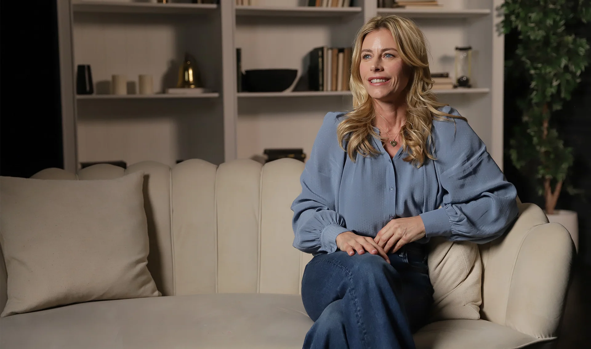 Julie du Page talking while seated on a couch.