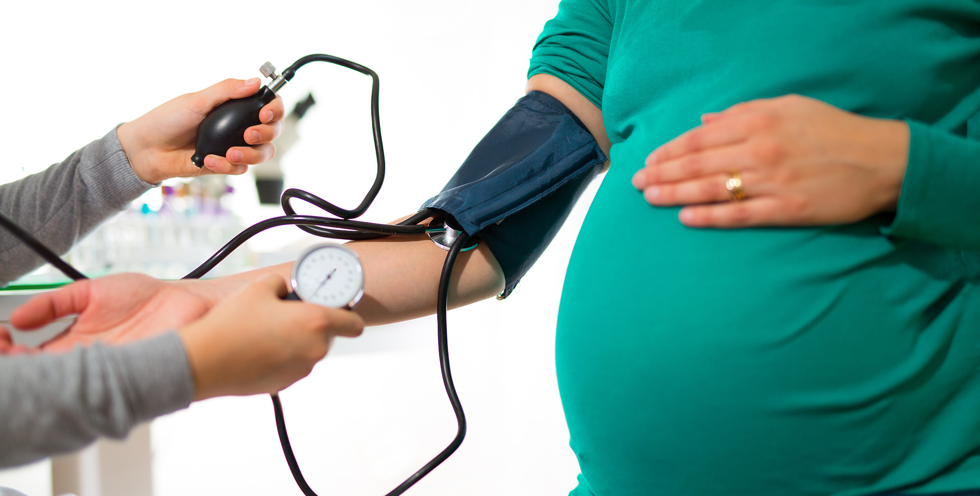 A pregnant woman at a doctor’s office getting her blood pressure measured