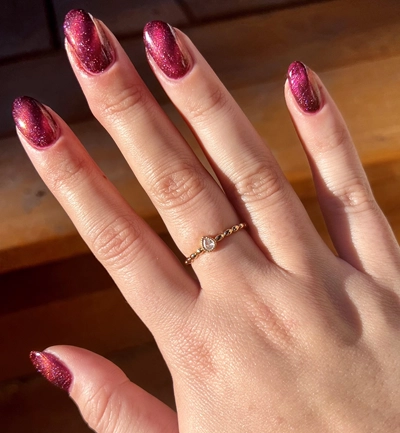 Melissa’s hand with painted nails.