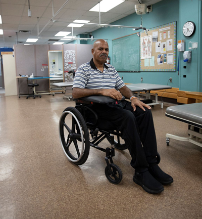 Michael Reynos sitting in a wheelchair. 